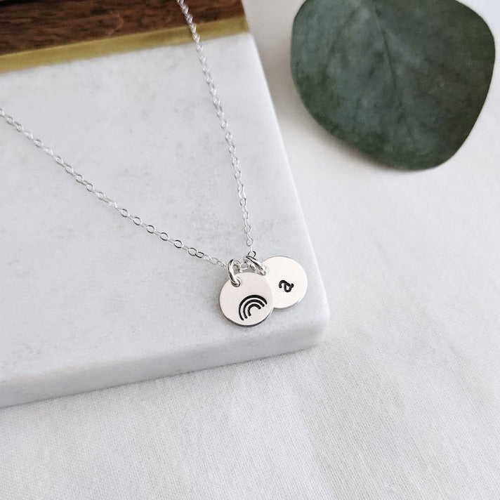 silver necklace with rainbow charm and initial