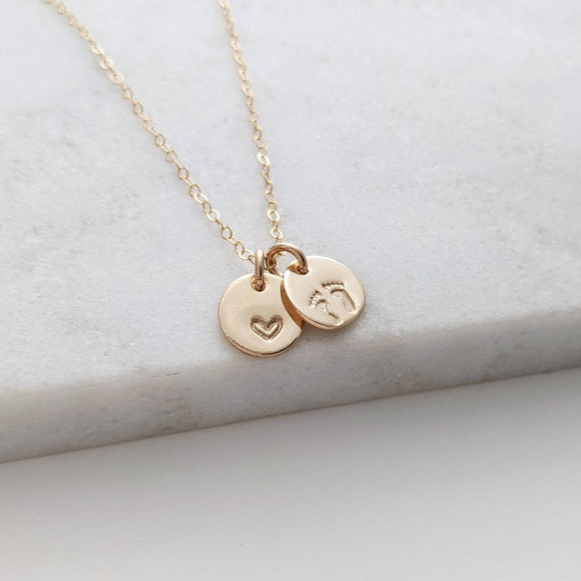 charm necklace with one heart charm and one footprint charm available in 14k gold fill or sterling silver