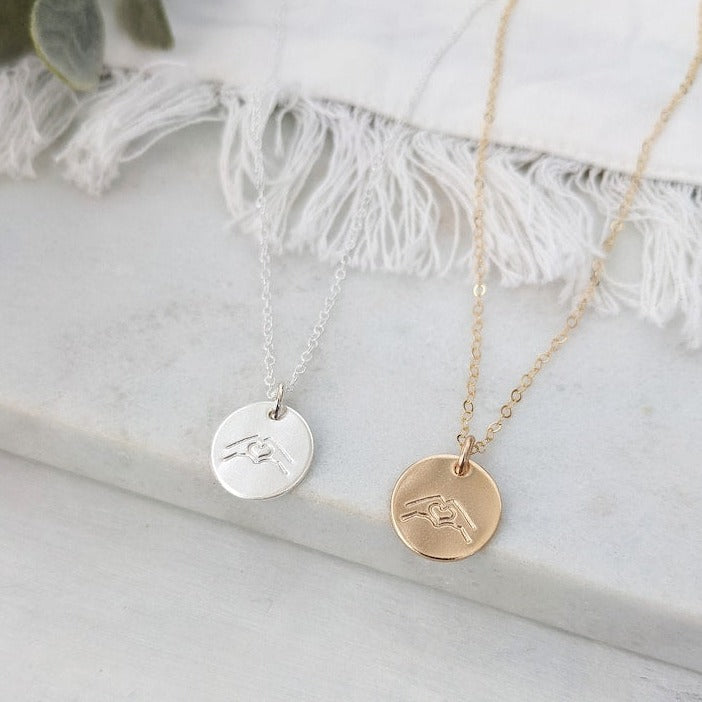 disc necklace with hand gesture necklace
