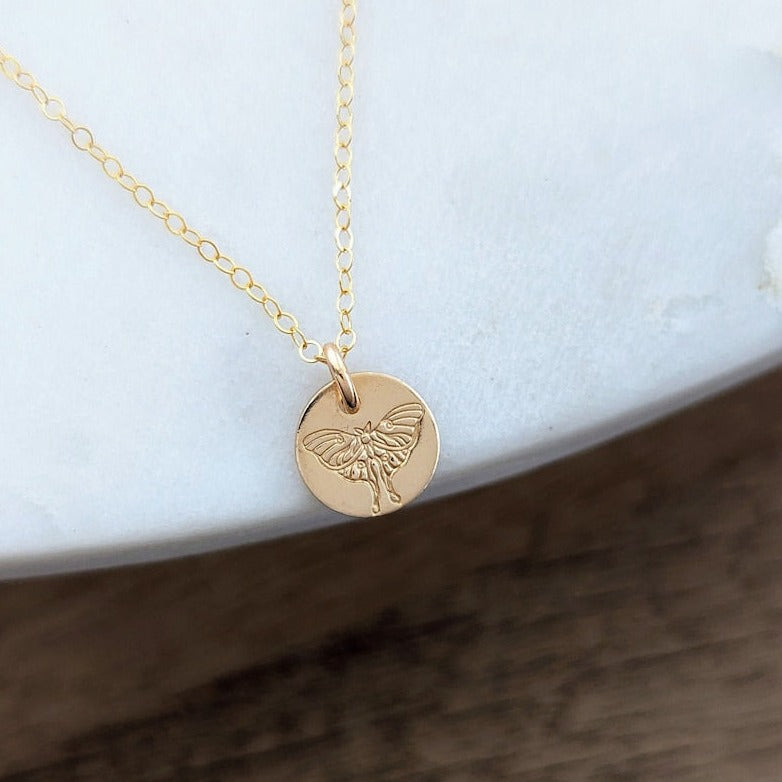 gold filled disc with lunar moth
