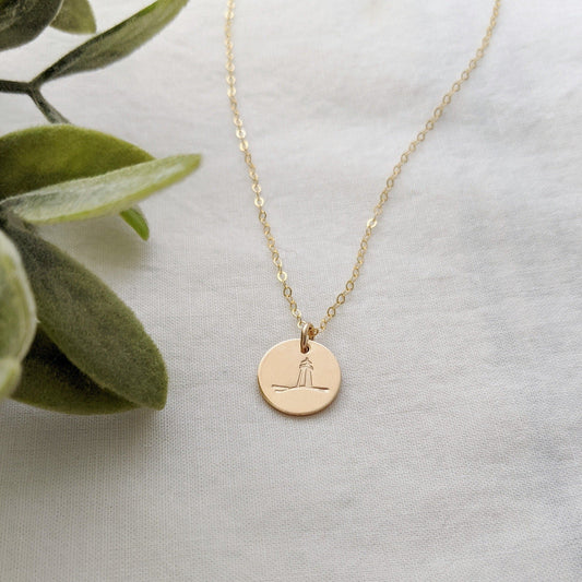 gold filled disc with lighthouse