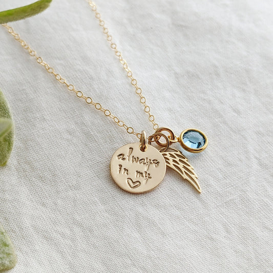 Necklace with always in my heart gold disc, wing charm and birthstone crystal