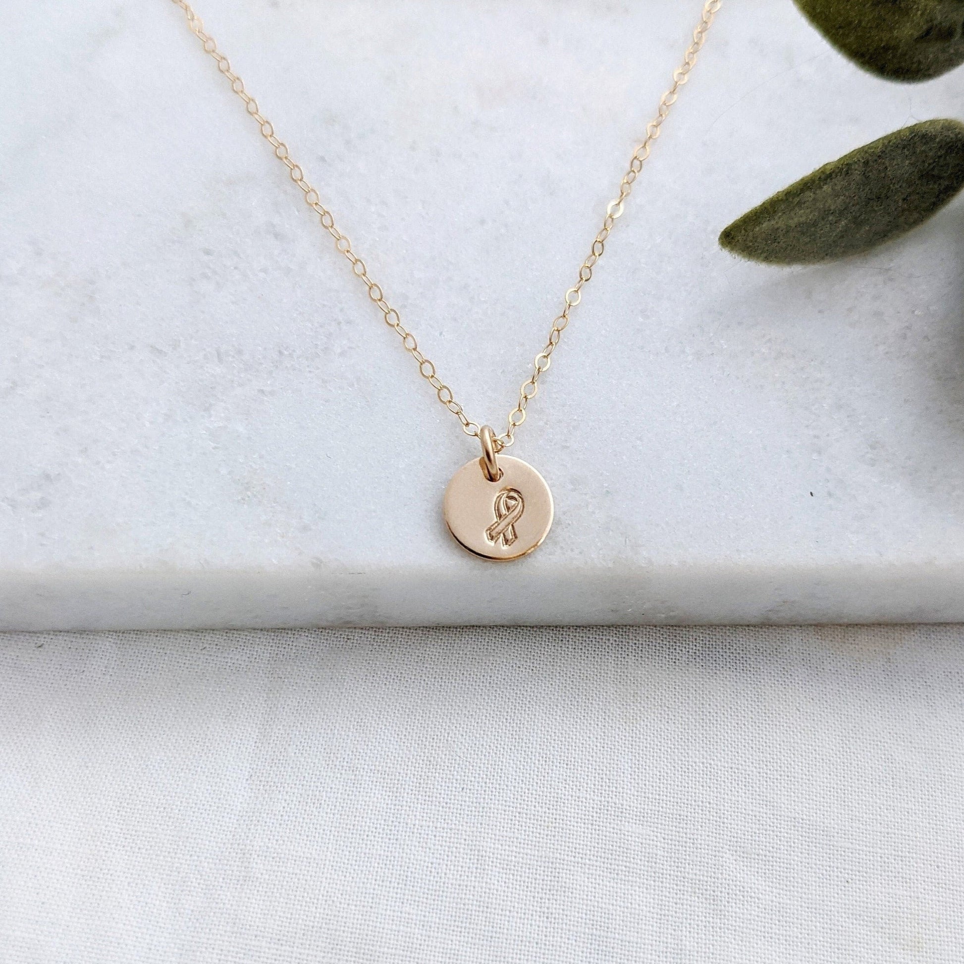 small disc necklace with awareness ribbon