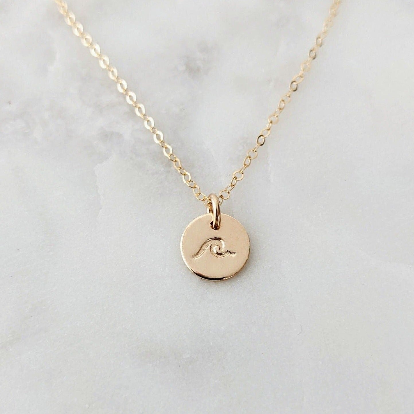 tiny gold disc necklace with wave