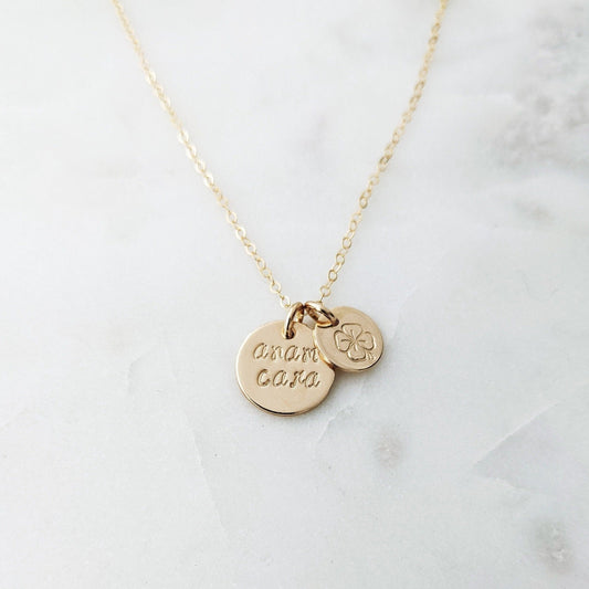 gold disc with anam cara and smaller disc with four leaf clover